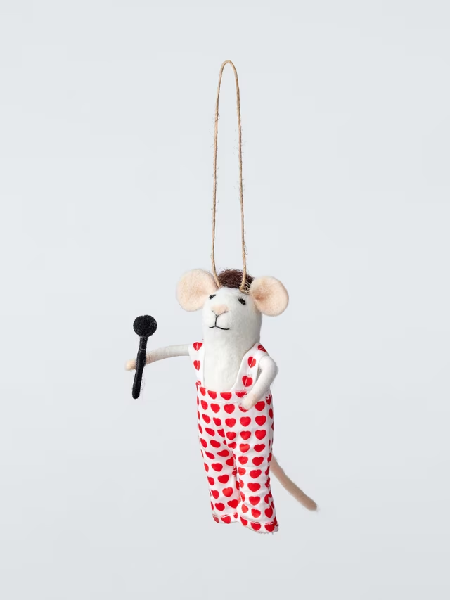 A felt mouse hanging Christmas ornament dressed in white overalls patterned with red hearts, holding a black microphone.